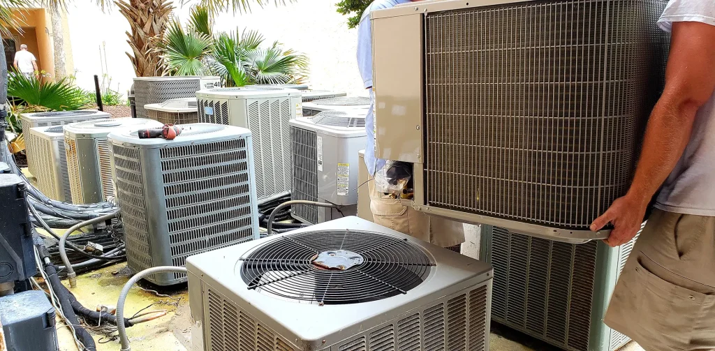 hvac-technician-removing-old-rusted-broken-aircond-2023-11-27-05-03-37-utc